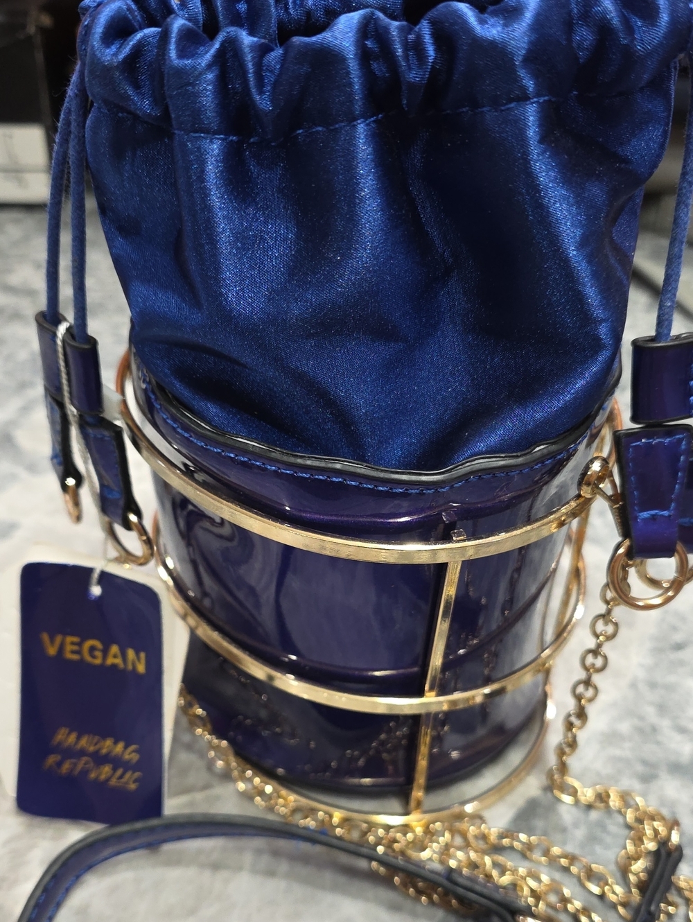 Vegan Royal Blue Drawstring Bucket Bag with Gold Cage Detail